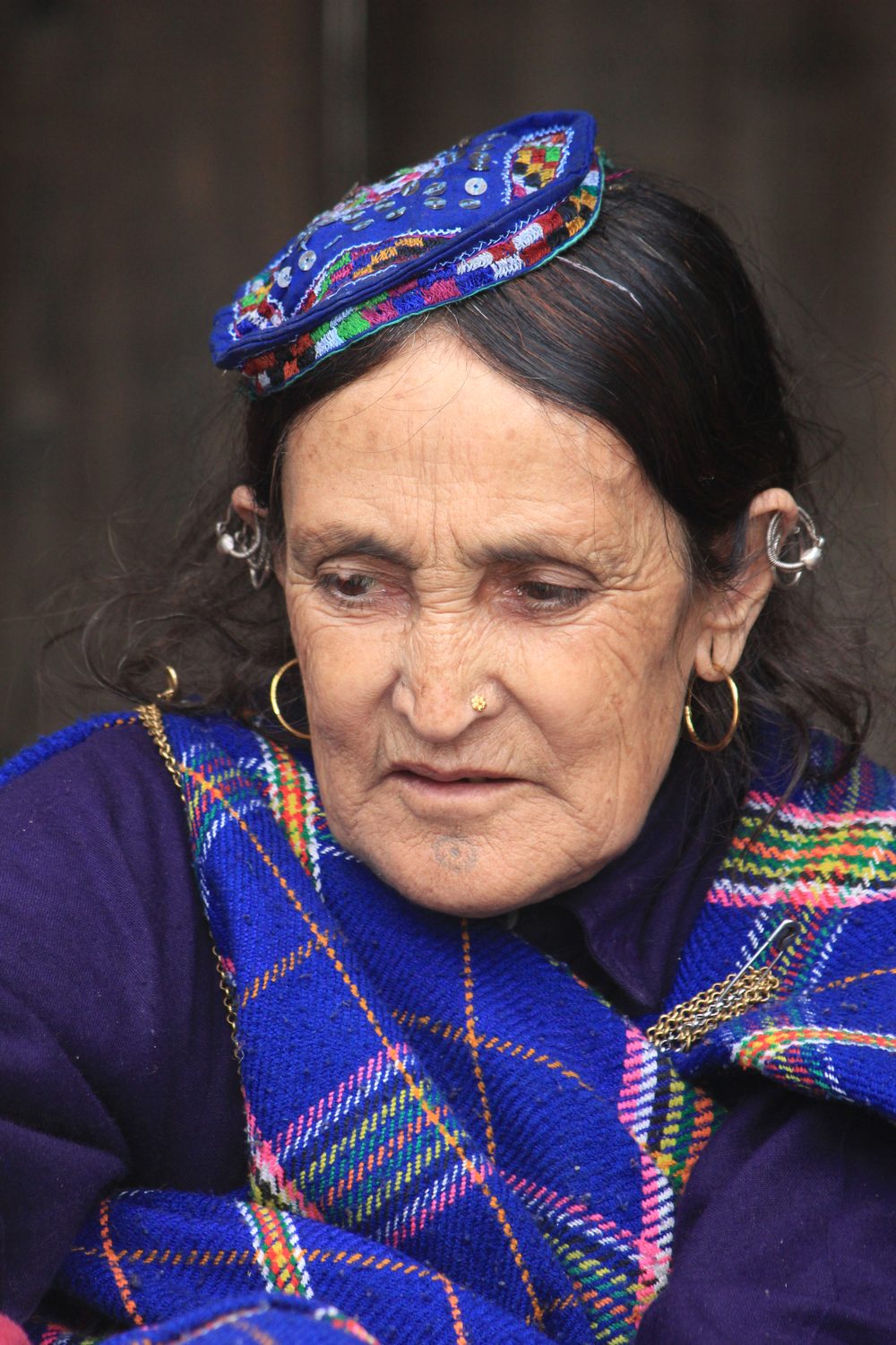 Elderly woman in traditional blue shawl, Pangi Valley