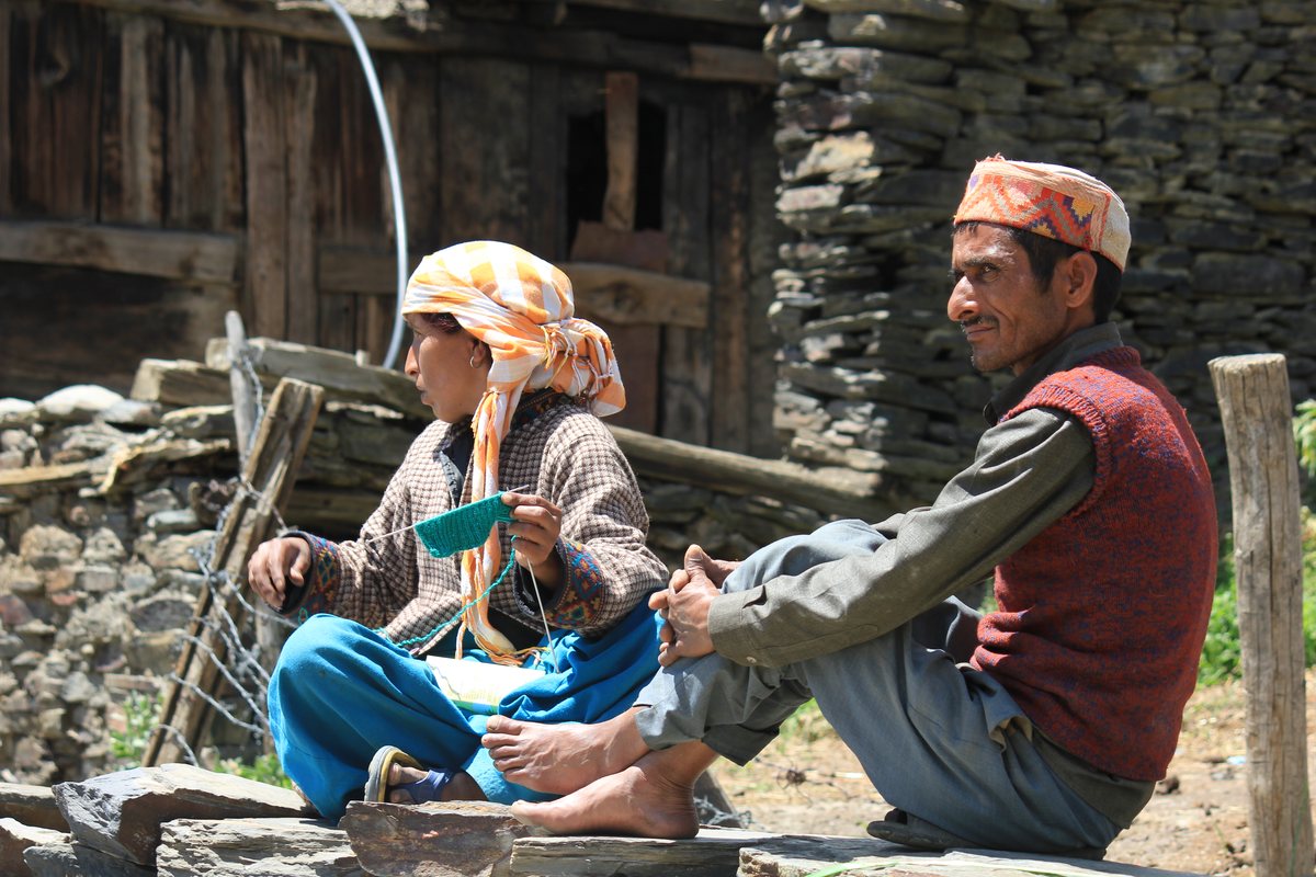 Host and guest talking on a porch in Pangi Valley